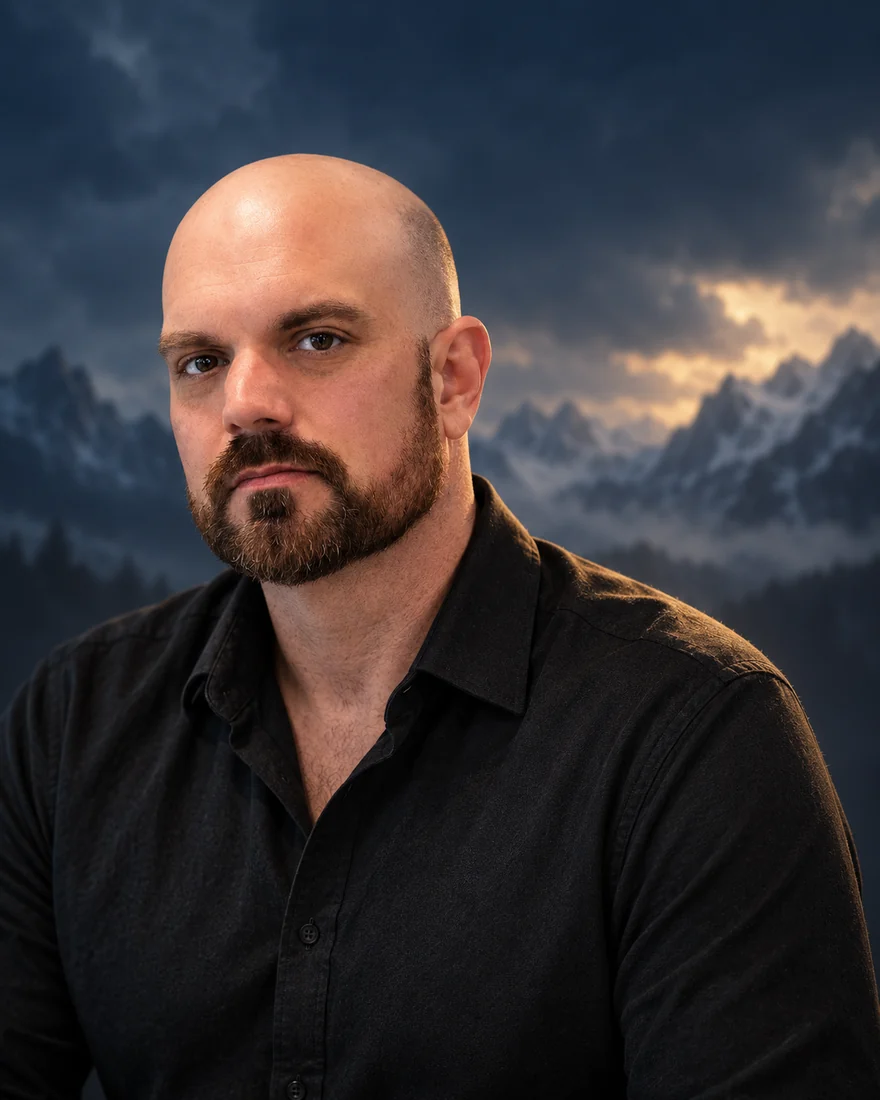 Portrait of Justin Pulliam, author of The Crownless Age, against a stormy mountain sky